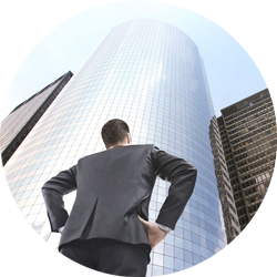 The photo shows a man looking at a building. He is responsible for a Excellent Onboarding – Merger & Acquisition's Secret Weapon